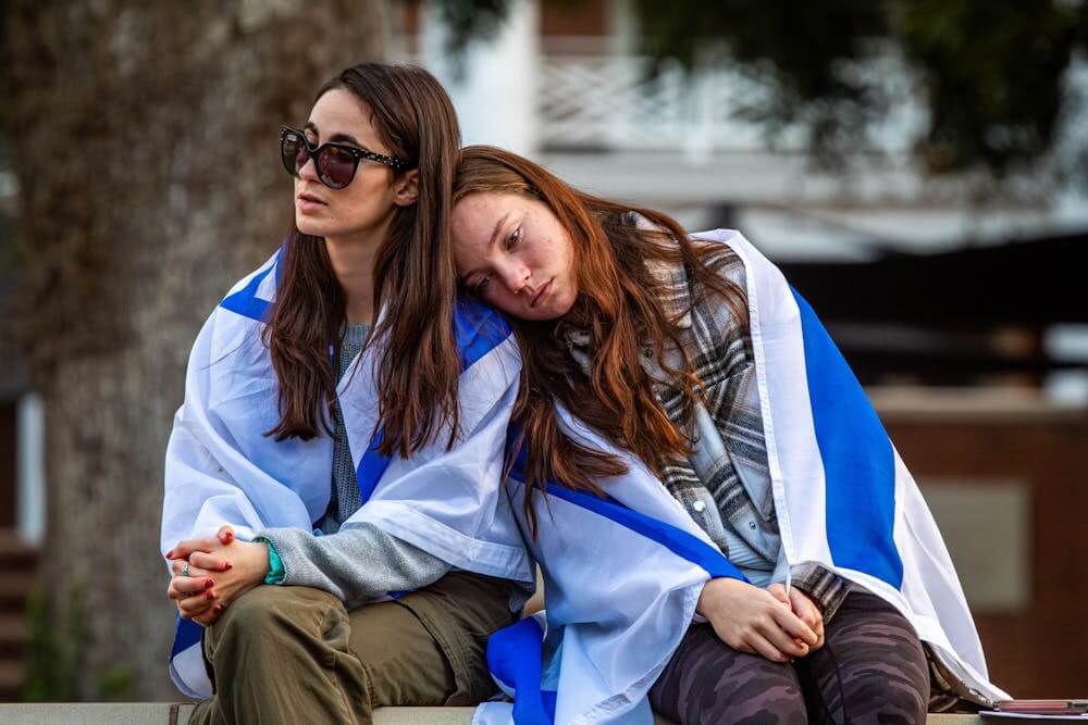 Casey Baldwin leans on Adina Spiewak's shoulder on Phi Beta Kappa Commons at Elon University on Oct. 9, 2023, during an event held to support those affected by the Israel-Hamas war.