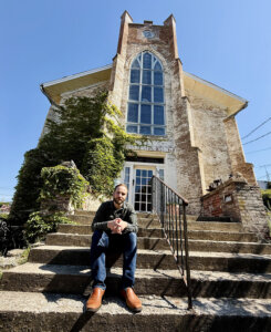 Austin Albanese in front of the former Congregation B'nai Israel in Lancaster, Ohio. The building was originally constructed in 1851 as a church.