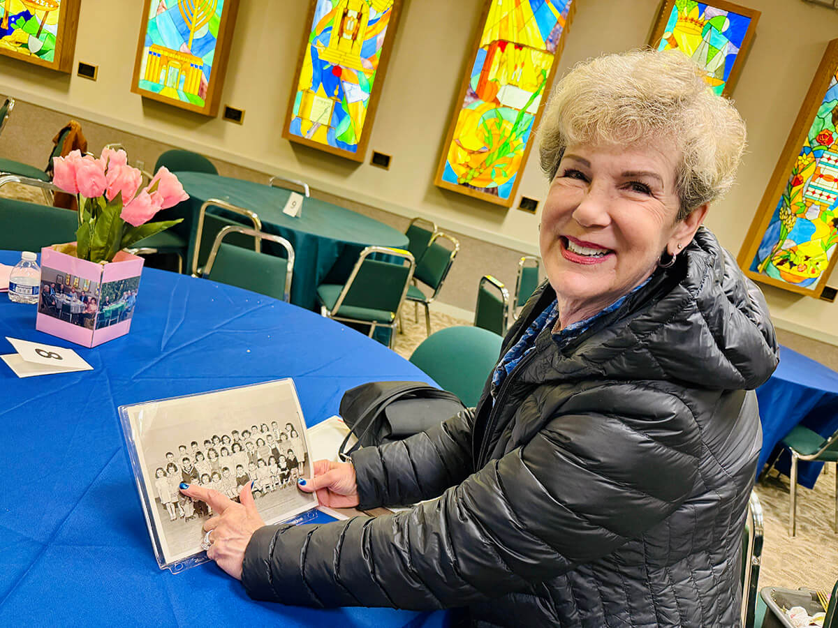 Ava Wilner Blecher points to her Temple B'nai Israel nursery school photo. She flew in from Scottsdale, Arizona for the synagogue's final service.