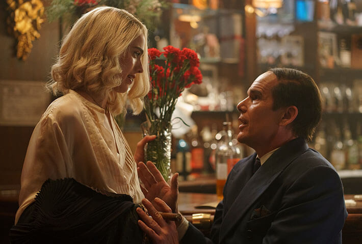 Margaret Qualley as Elizabeth Weiland and Ethan Hawke as Lorenz Hart in <i>Blue Moon.</i>
