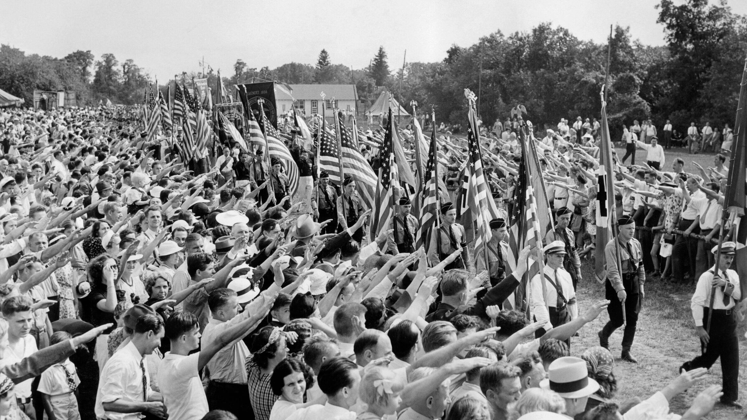 Hundreds of thousands of German-Americans show their affinity for Hitler by raising their hands in a Nazi salute during an annual "German Day" at Camp Siegfried in Long Island, 1937.