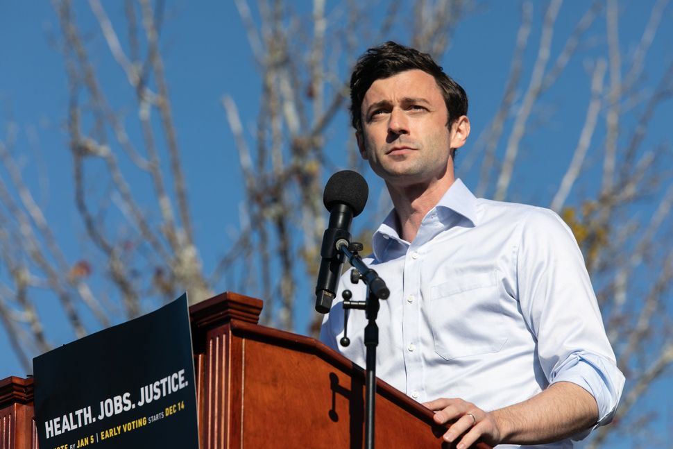 Jon Ossoff speaks to the crowd during a rally in December 2020 in Conyers, Ga.