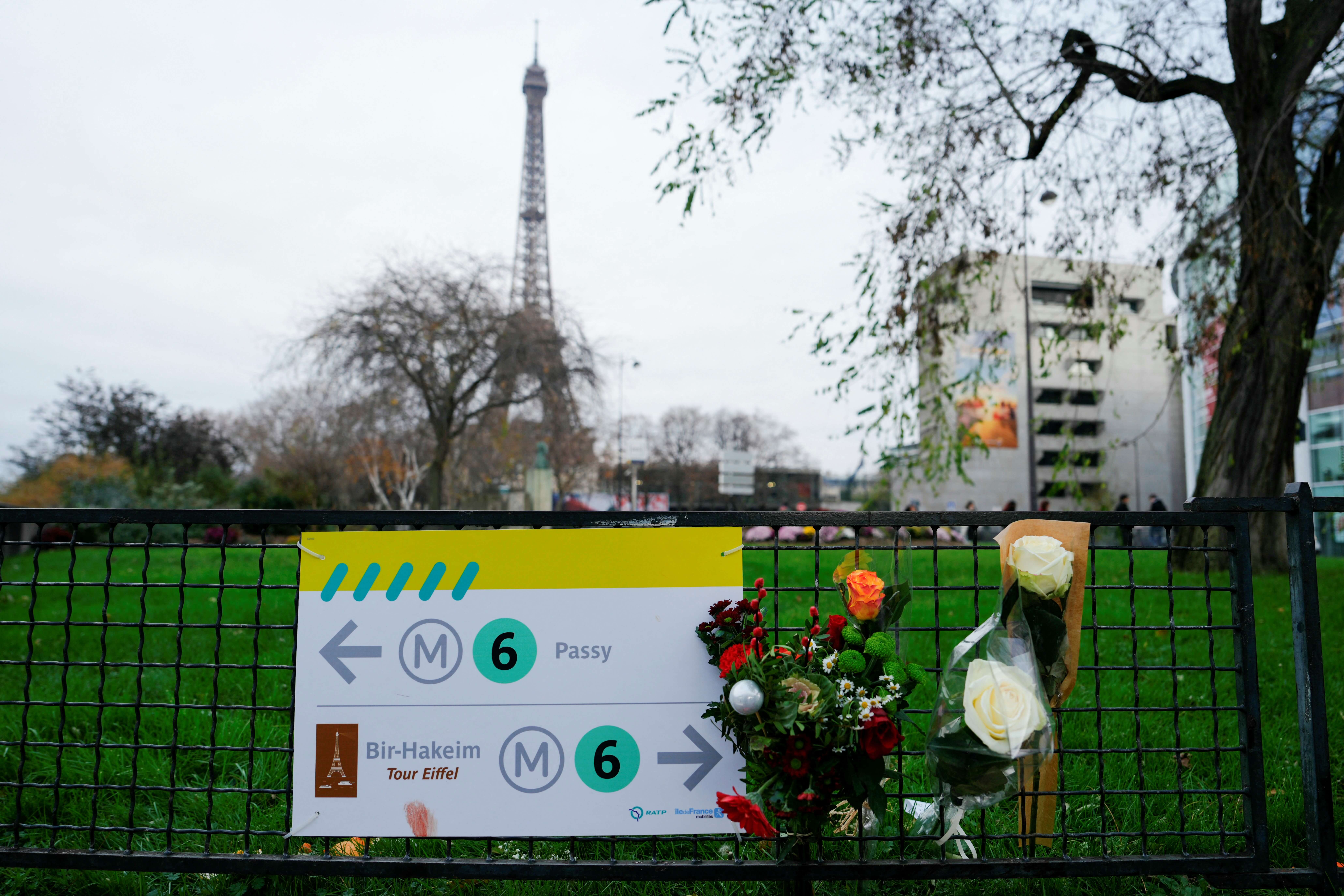 Flowers are displayed near where a tourist was stabbed to death near the Eiffel Tower on Dec. 2, 2023.