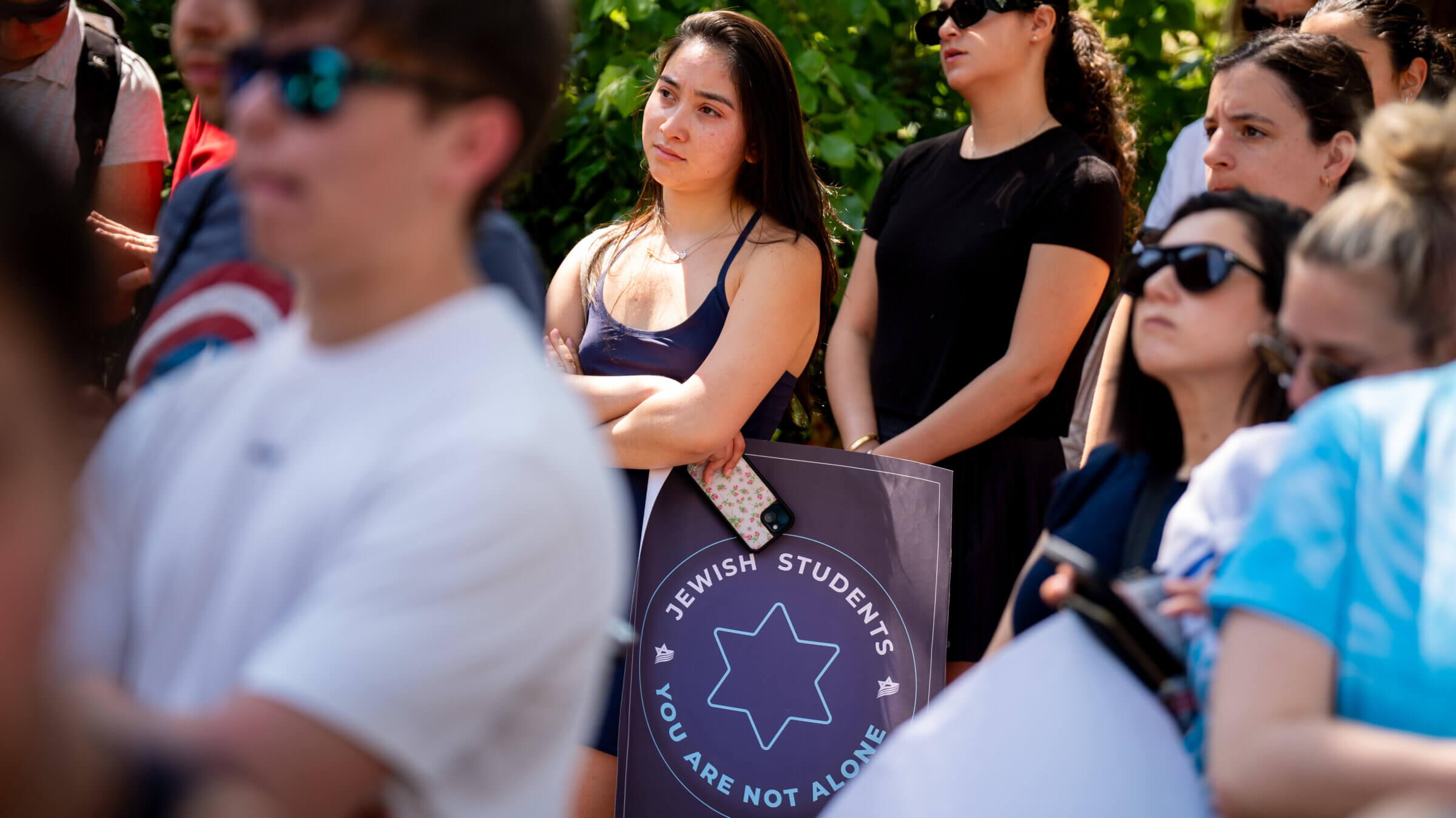 A woman holds a sign supporting Jewish students during a rally against campus antisemitism at George Washington University on May 2, 2024.