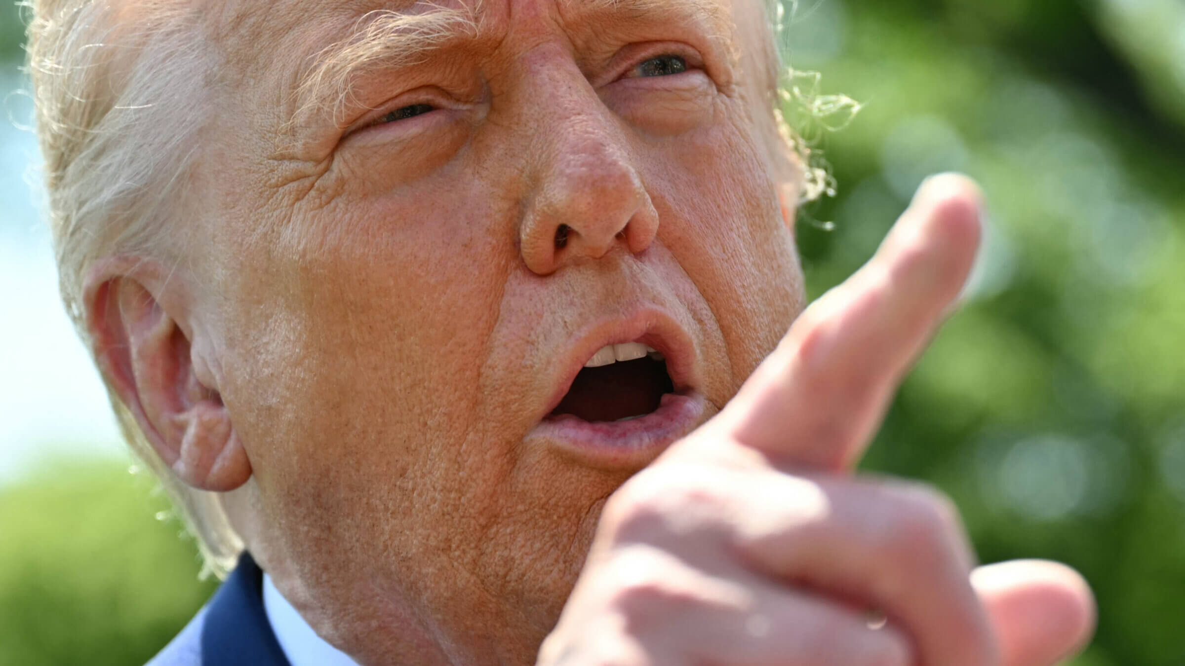 Donald Trump speaks to the media as he walks to board Marine One at the White House.