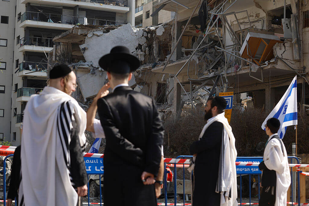 Israelis observe damaged buildings after Iranian strike on June 14. 
