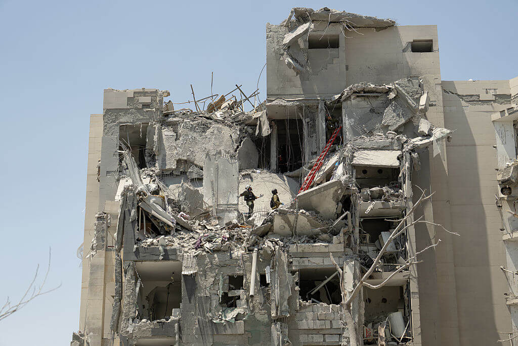 Israeli emergency responders work at a building where four people were killed by an Iranian missile strike in Beersheba on June 24.