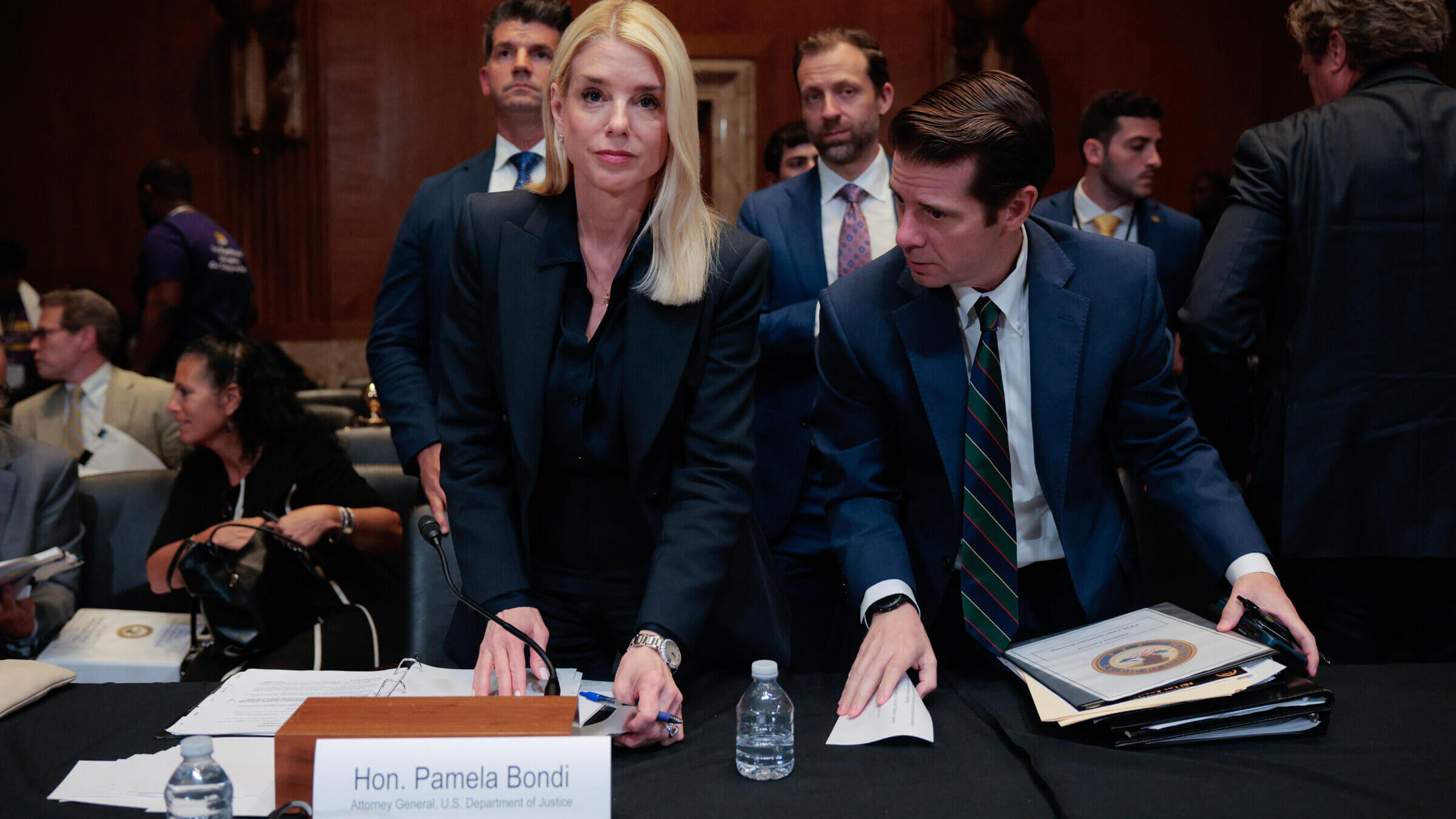 Attorney General Pam Bondi gathers her things after testifying before the Senate Appropriations Committee on June 25.