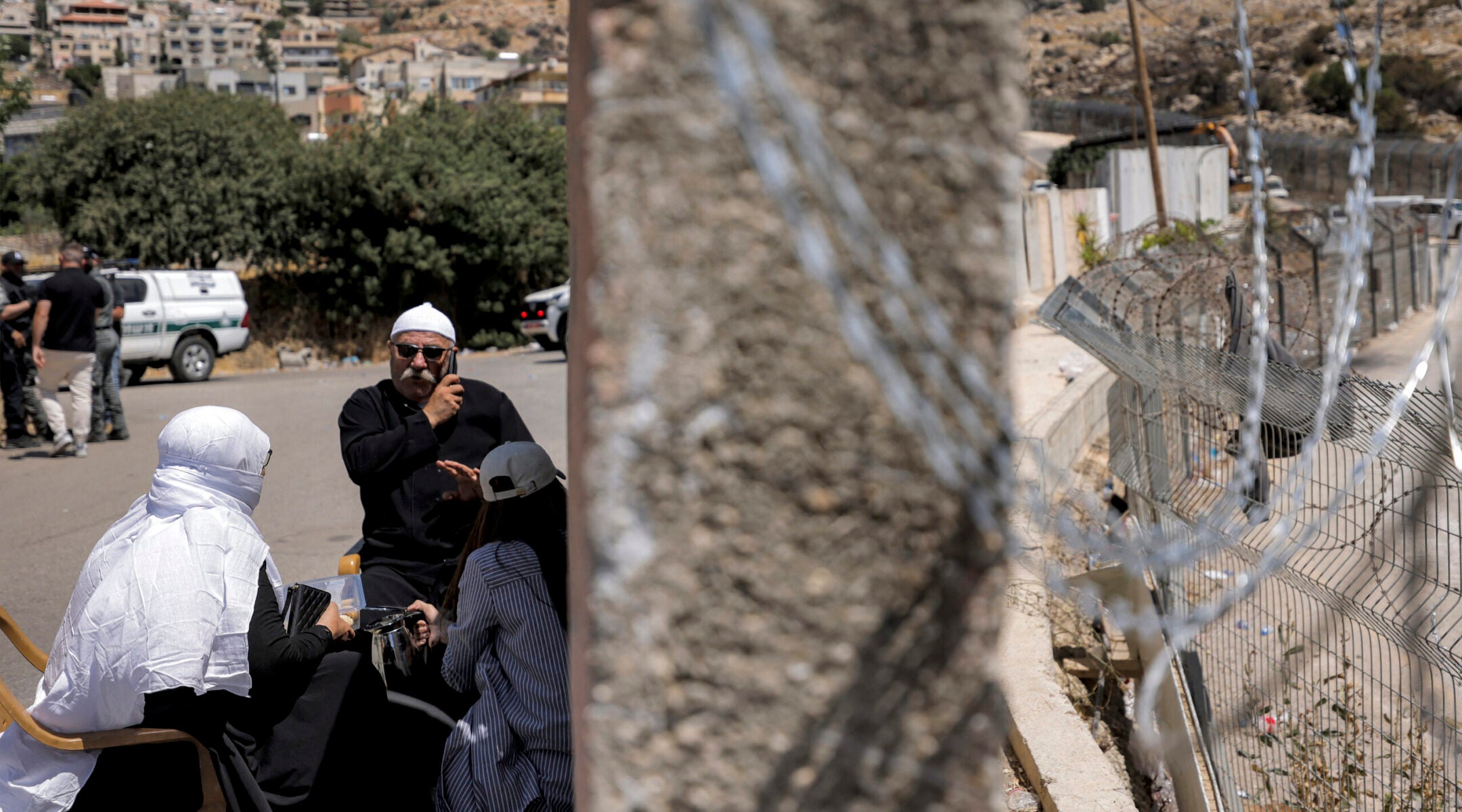Members of the Druze community gather along the dividing line with the buffer zone as they wait for a chance to see relatives on the Syrian side near the Druze village of Majdal Shams, in the Golan Heights region of Israel, on July 19, 2025.