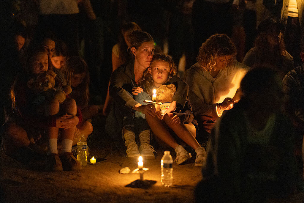 People attend a vigil to mourn the dead and pray for the wounded after a gunman opened fire on students at Annunciation Catholic School on August 27, 2025 in Minneapolis.