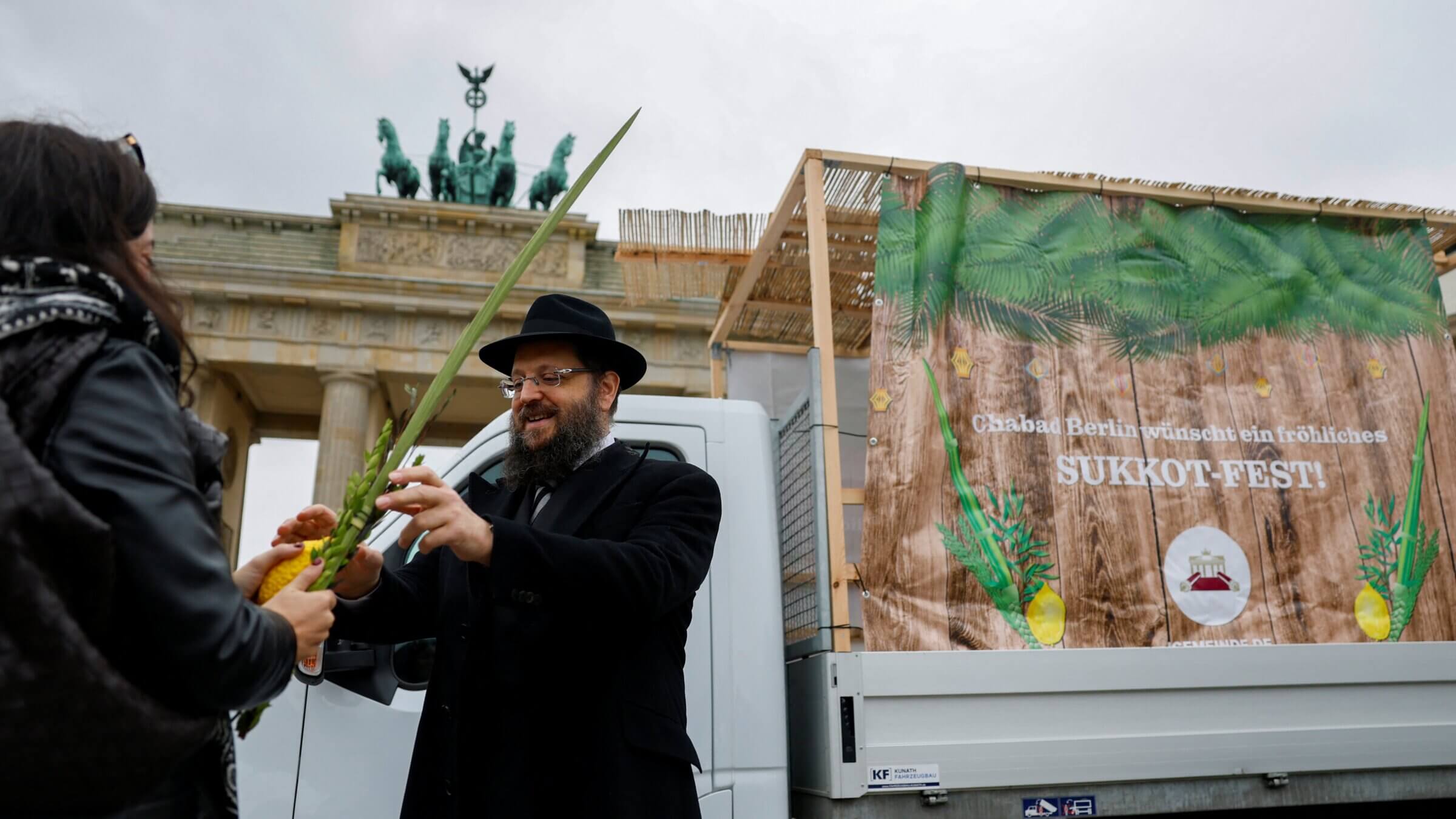 A Chabad rabbi offer prayers in front of a mobile "Sukkah" to celebrate the Jewish holiday of Sukkot at Brandenburg Gate in Berlin.