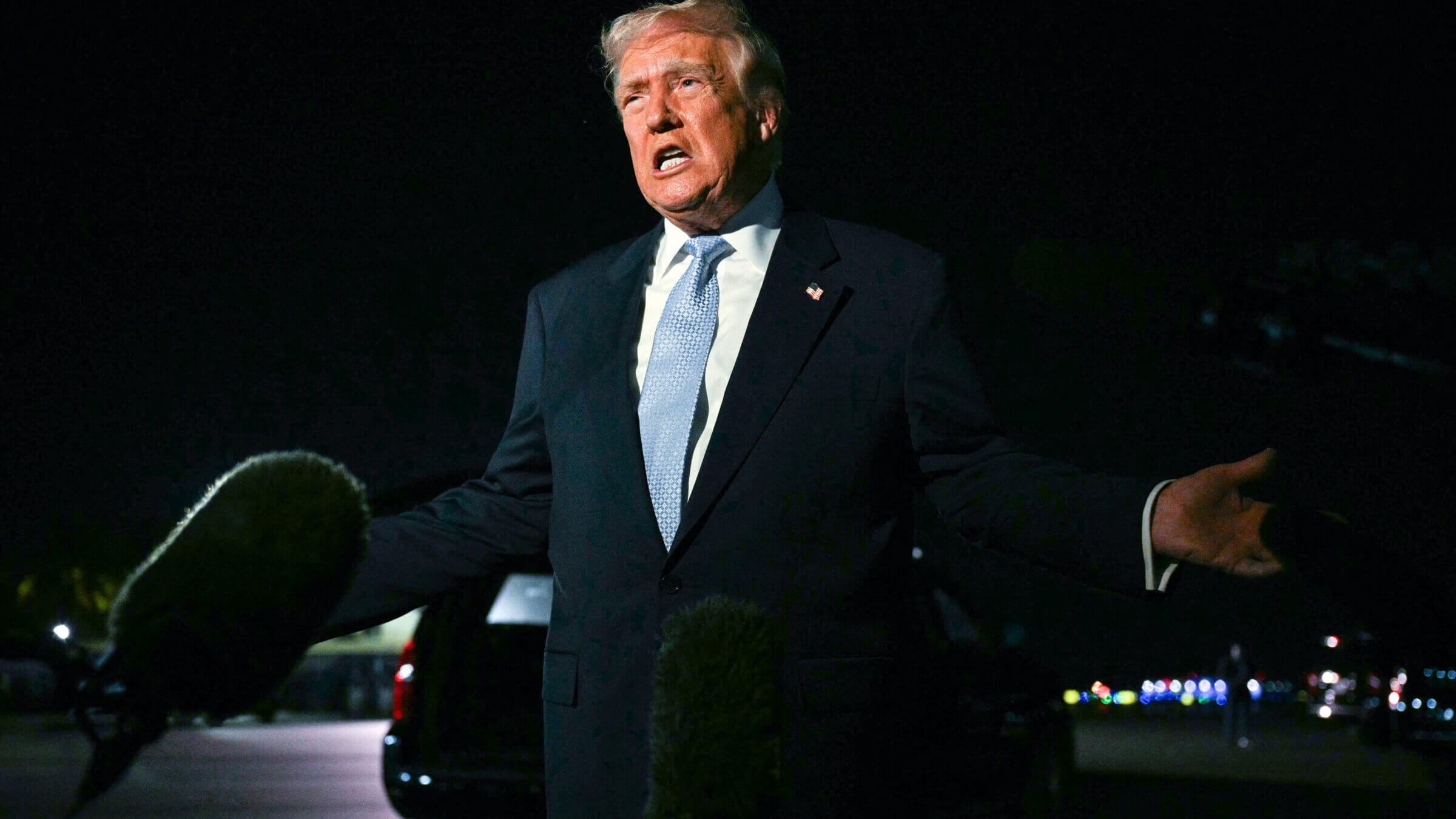 President Donald Trump speaks with reporters before boarding Air Force One as he departs West Palm Beach, Florida, Sunday night to return to the White House on November 16.