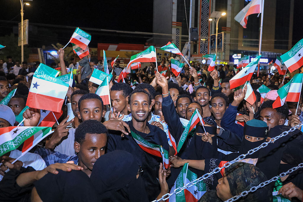 Residents wave Somaliland flags as they gather to celebrate Israel's announcement recognizing Somaliland's statehood in downtown Hargeisa.