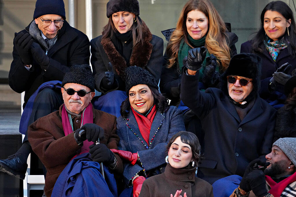 Mahmood Mamdani, left, and Mira Nair, second left, parents of Zohran Mamdani, during an inauguration ceremony at City Hall in New York on Thursday, Jan. 1, 2026. 
