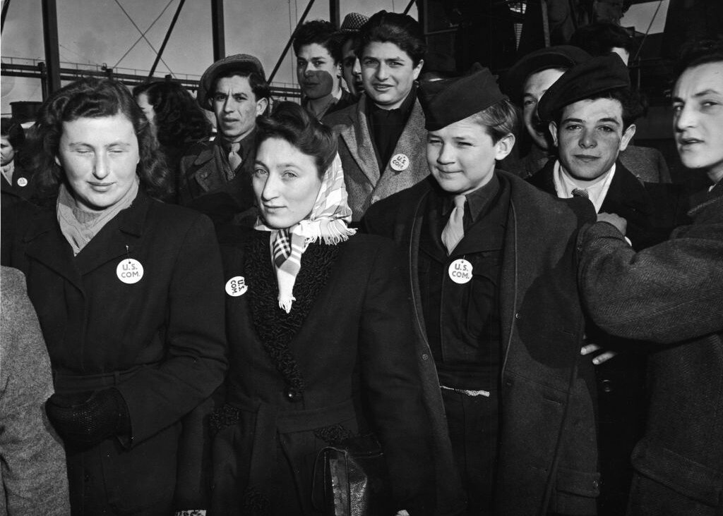 A group of unidentified children and young adults stands on the deck of the S.S. Marine Perch as it arrives in the United States bringing immigrants and World War II refugees from Europe, to New York, likely February 1947.