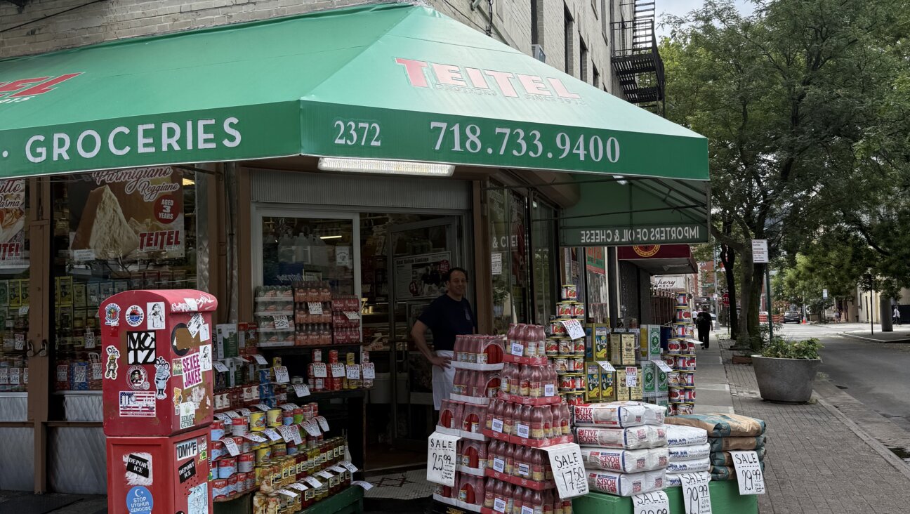 Teitel Brothers Wholesale Grocery on Arthur Avenue and 186th Street. Eddie Teitel stands by the entrance.