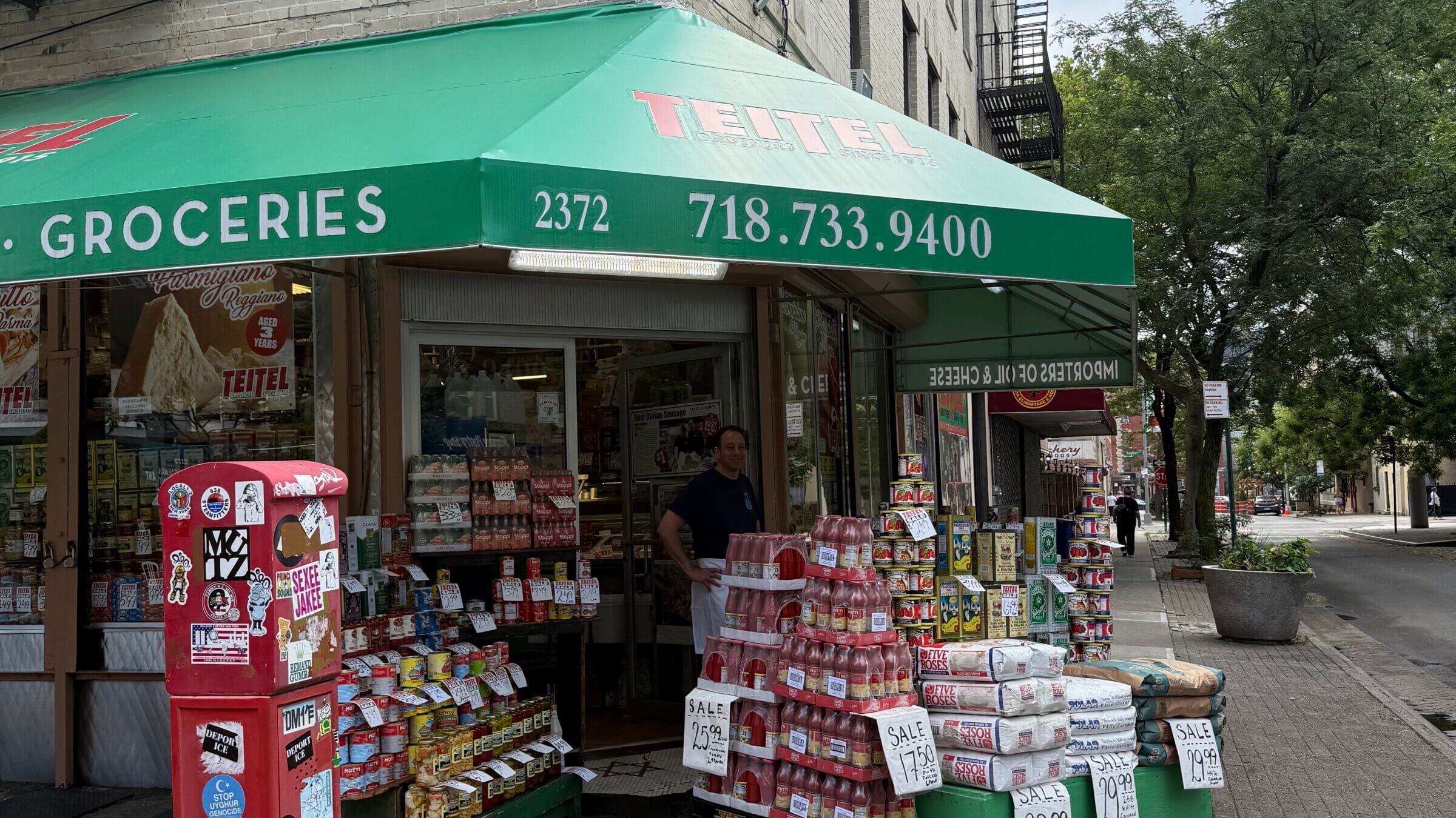Teitel Brothers Wholesale Grocery on Arthur Avenue and 186th Street. Eddie Teitel stands by the entrance.