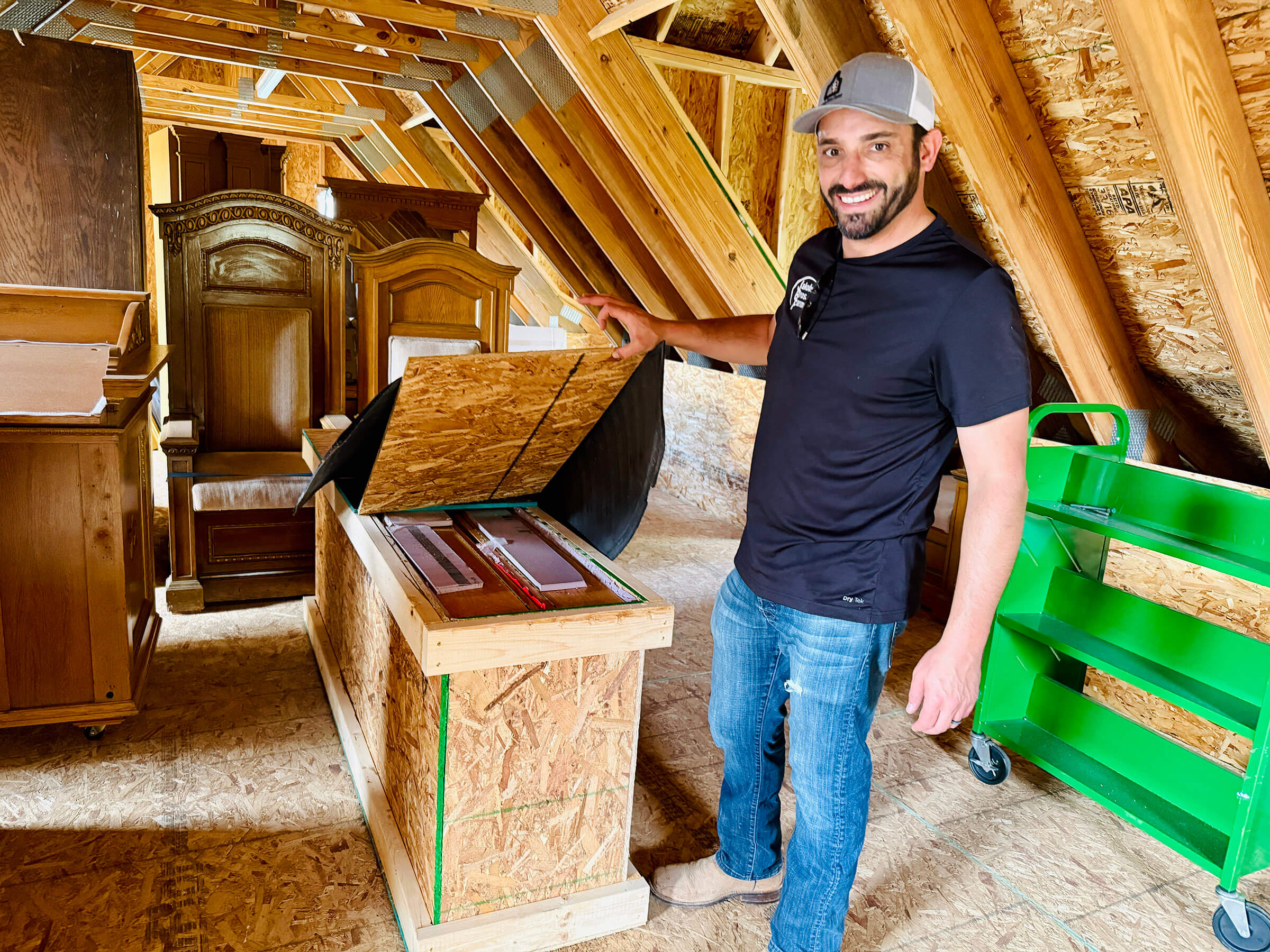 Nik Jakobs with the boxed up stained glass windows, rabbi's chairs and bimah that he helped rescue from a century-old synagogue in Pennsylvania that closed down. He plans to use them in a new shul being built in Sterling, Illinois.