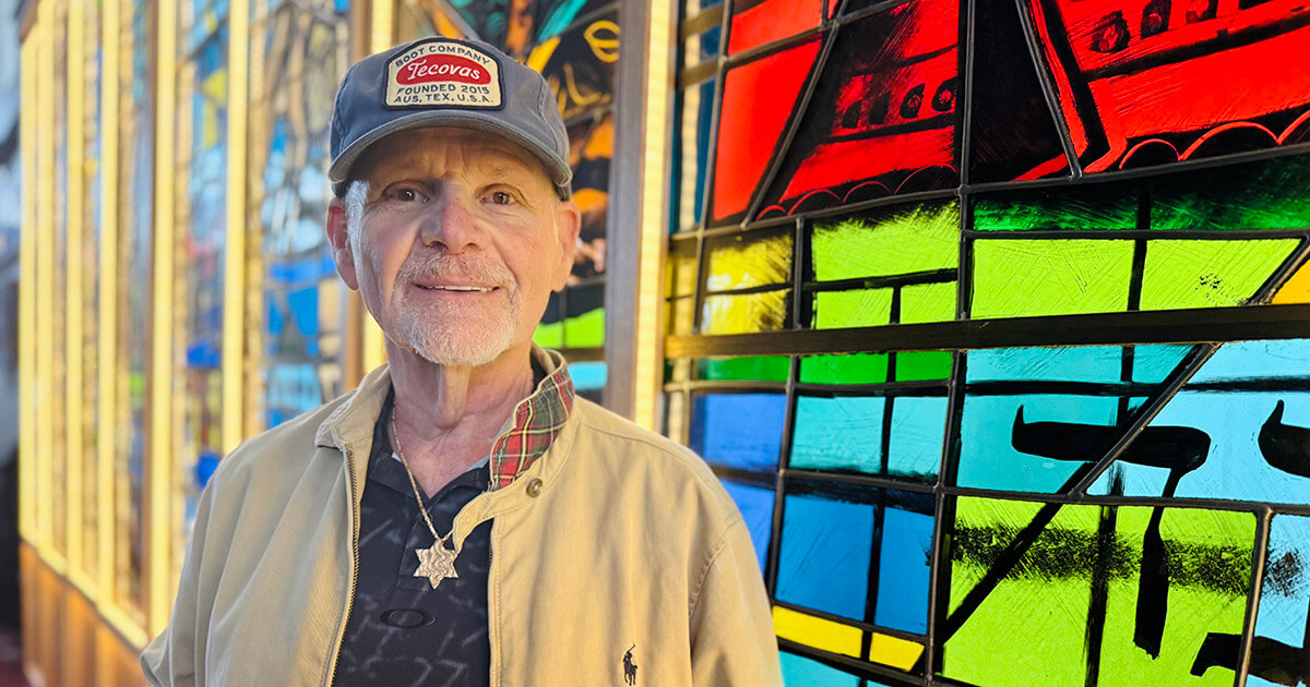 Jerry Orbach at Northbrook Community Synagogue in front of stained glass windows he rescued from Temple B'nai Israel, a shuttered synagogue in Saginaw, Michigan.