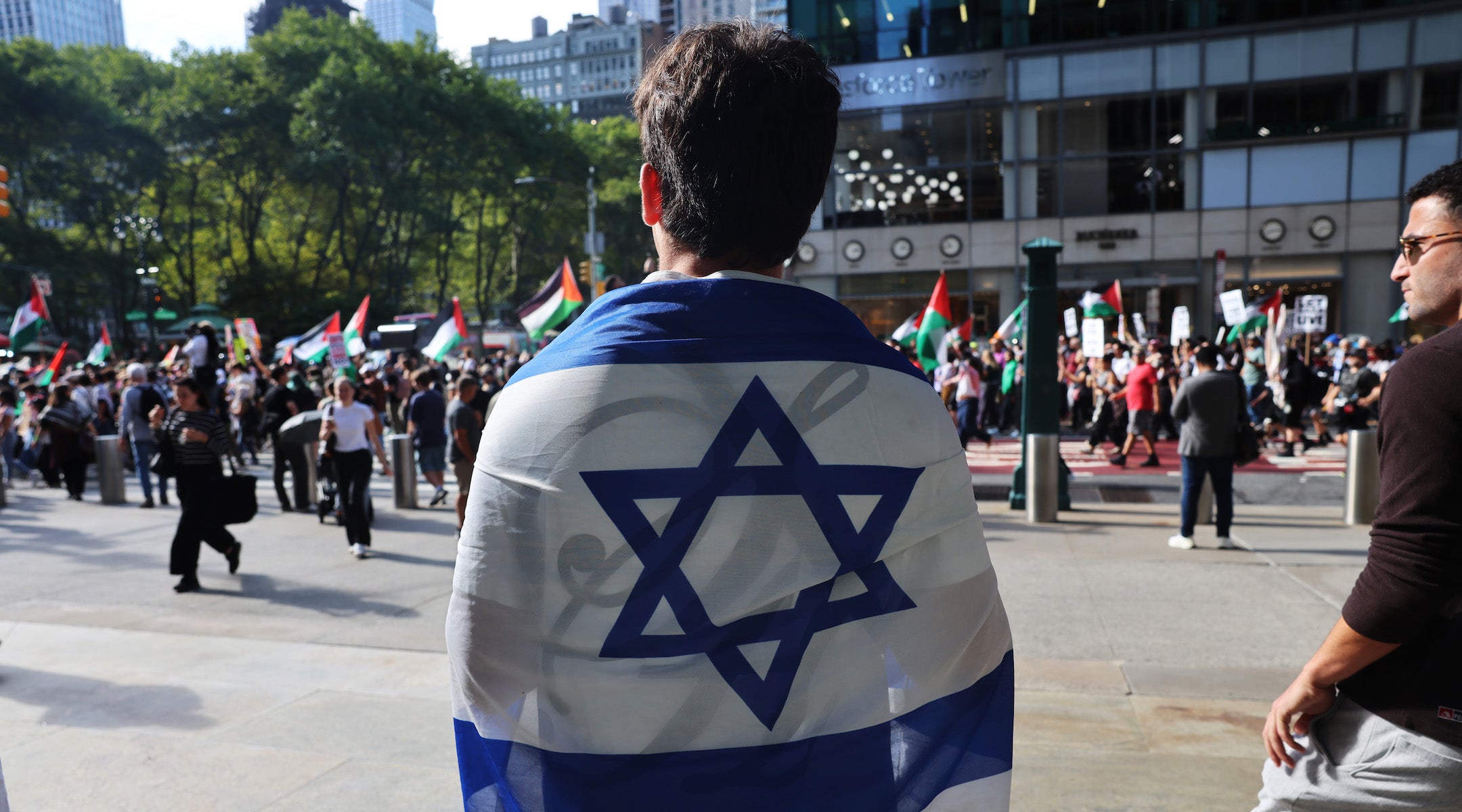 A man holds an Israeli flag as Pro-Palestinian protesters march through Manhattan near the United Nations as Israeli Prime Minister Benjamin Netanyahu addresses the United Nations General Assembly on Sept. 26. 