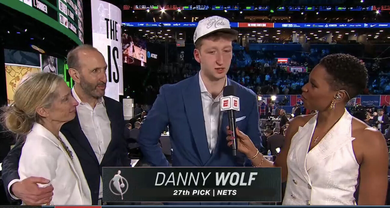 Danny Wolf with his mother Tina, his father Joe and ESPN's Monica McNutt after being his selection by the Nets.