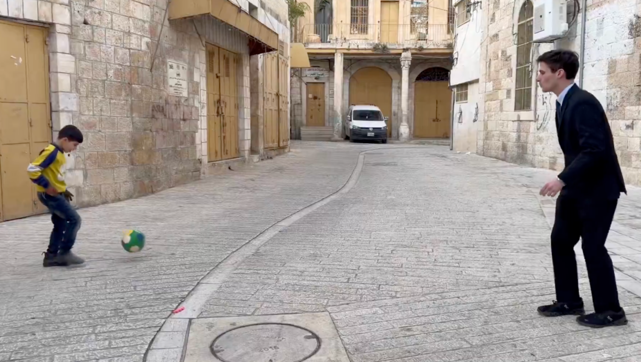 Congressional candidate Cameron Kasky playing soccer with a Palestinian child during his trip to the West Bank, Dec. 2025. 